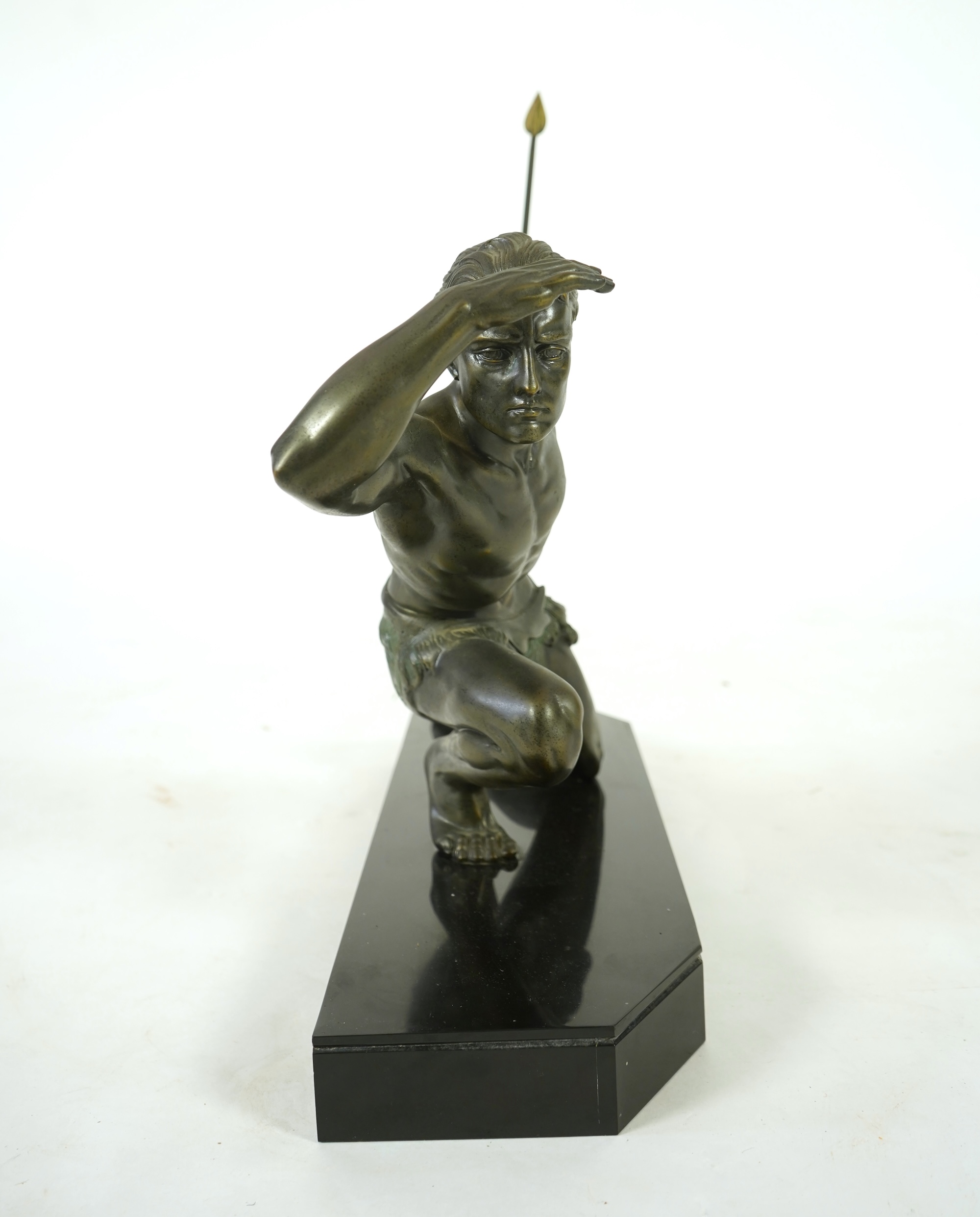 Manner of Jean de Roncourt (1869-1937) An Art Deco patinated bronze sculpture of a male hunter with spear on black marble stand